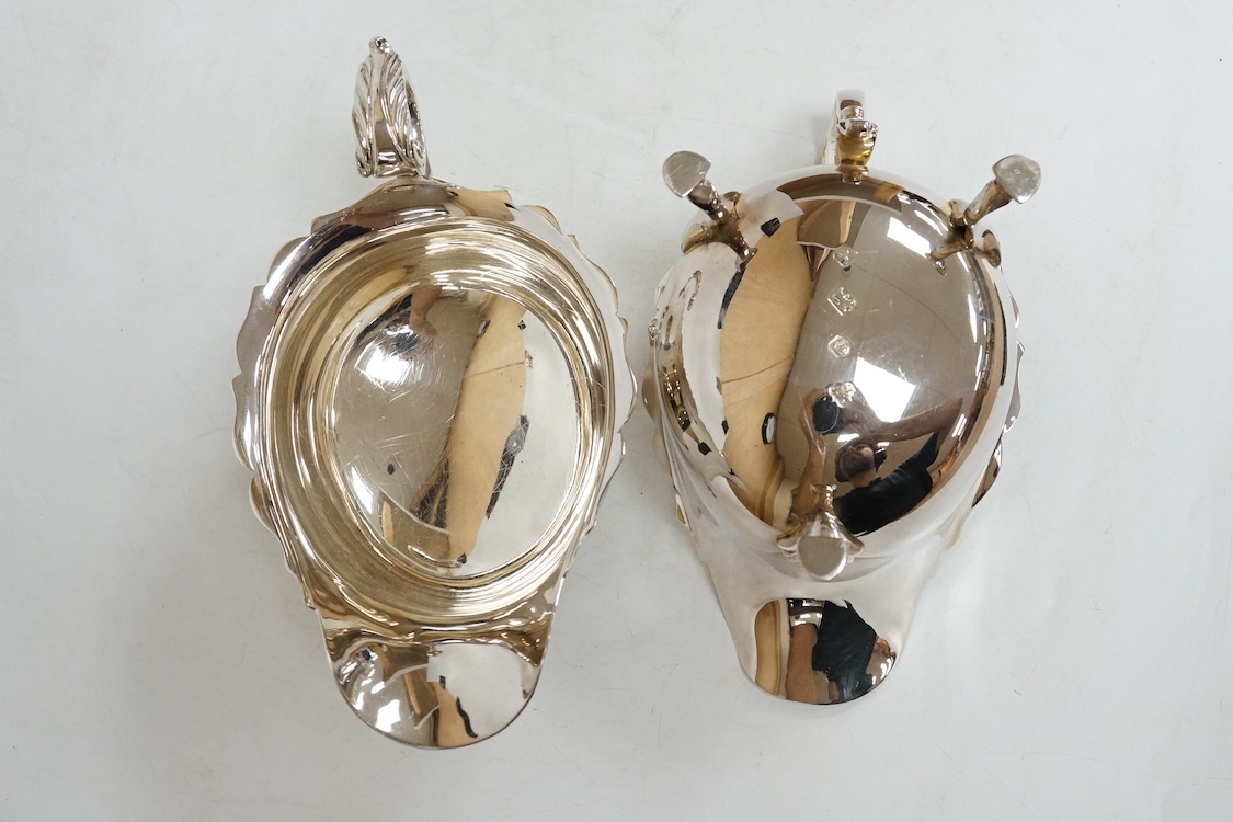 A pair of modern silver sauceboats, with flying scroll handles, C.J. Vander Ltd, Sheffield, 1989, length 14.9cm, 9.5oz.